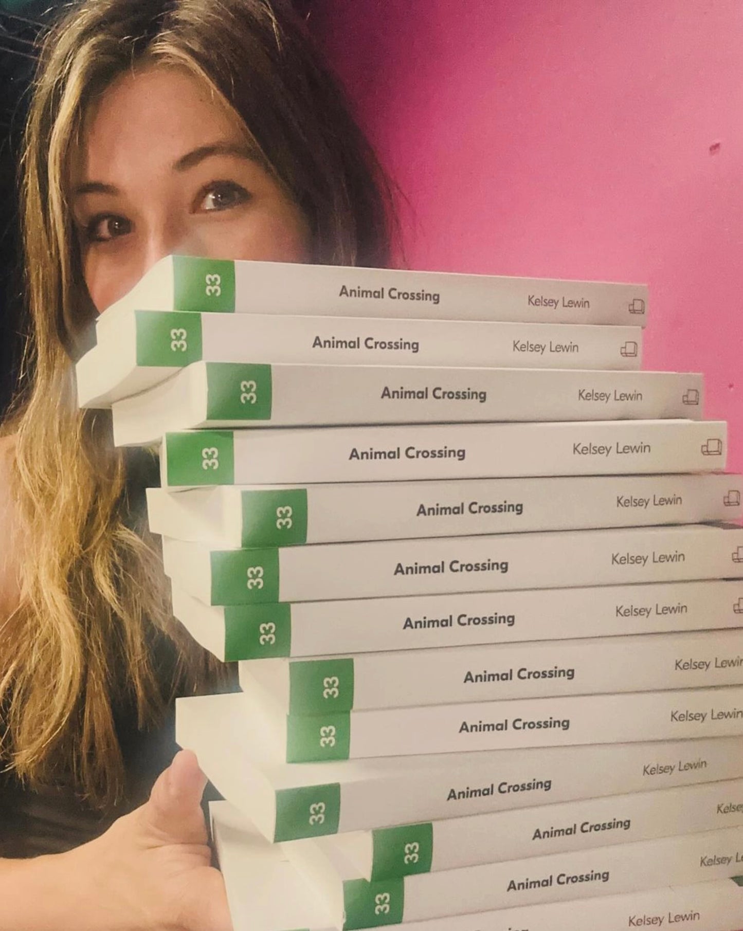 The author with a big stack of books